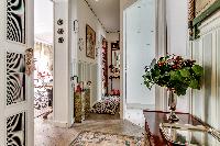 a hallway with parquet floors in a 1-bedroom Paris luxury apartment