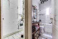spotless modern tile and marble finished bathroom with shower, bathtub, sink, toilet, and a hairdrye