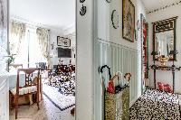 a hallway with parquet floors in a 1-bedroom Paris luxury apartment