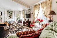 elegantly decorated living area with a handful of decors,elegant furniture, and numerous works of ar