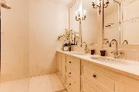 elegant bathroom finished with marbles and fancy tiles in 3-bedroom Paris luxury apartment
