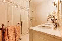 elegant bathroom finished with marbles and fancy tiles in 3-bedroom Paris luxury apartment