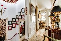 massively decorated hallway with access to the stairs and living room in 3-bedroom Paris luxury apar