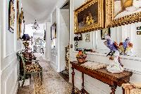 massively decorated hallway with access to the stairs and living room in 3-bedroom Paris luxury apar