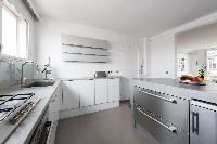 sleek white-and-grey kitchen in Paris luxury apartment