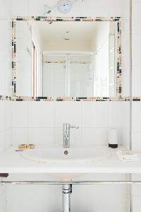 sleek shower area with sink in Paris luxury apartment