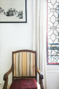striped dark wooden armchair in Paris luxury apartment