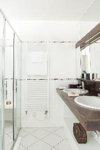 sleek shower area with double sink in Paris luxury apartment