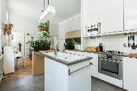 sleek white-and-gray kitchen in Paris luxury apartment
