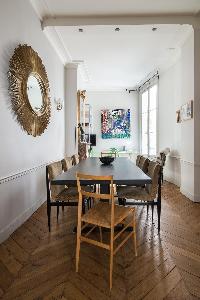 elegant dining room with eye-catching accessories, surrounds a dining table and a little desk in Par
