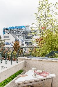 verdant balcony with triangular table overlooking Pompidou Centre