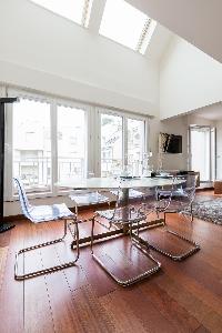 contemporary dining table with 6 ghost chairs in Paris luxury apartment