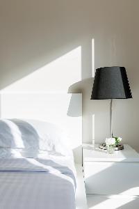 comfy bed beside black lamp in Paris luxury apartment