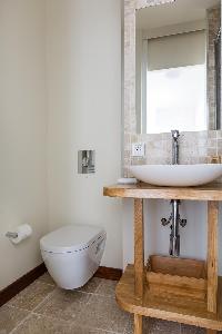 sleek white-walled toilet in Paris luxury apartment