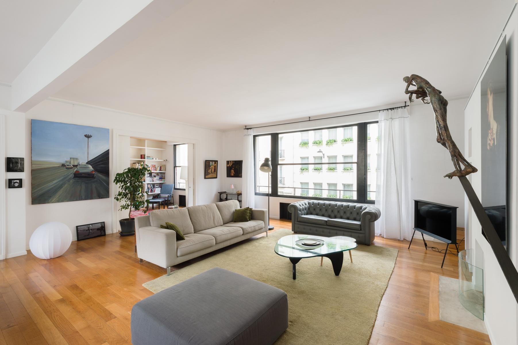 contemporary 4-bedroom Paris luxury apartment with gray and cream sofas
