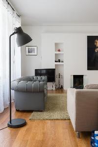 contemporary living room with understated sofas and armchairs sit surrounded by absorbing artworks i