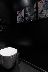 toilet in elephant grey hue with framed artworks in a Paris luxury apartment