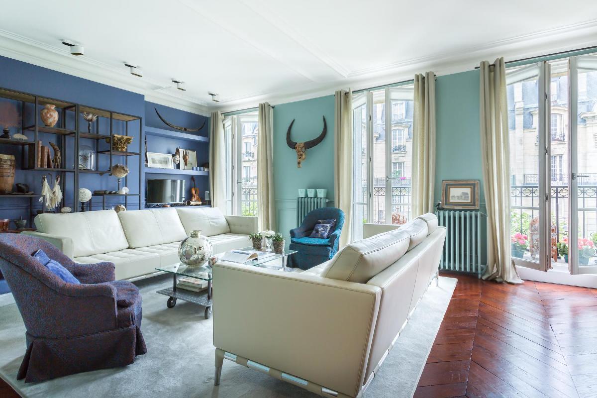 colorul and curio-filled sitting room in a 2-bedroom Paris luxury apartment