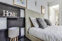 lovely bedroom with a queen-size bed and lamp in a Paris luxury apartment