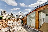 terrace with wonderful view of the Notre Dame de Paris in a Paris luxury apartment