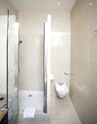 an en-suite bathroom with a sink, a toilet, and a full bath with a detachable shower head in paris l