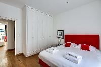 bedroom with a queen-size bed, two-bed side tables, and built-in cabinetsin paris luxury apartment