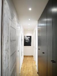 hallway with closet and work of art hanging on the wall  in paris luxury apartment