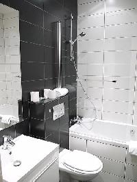 en-suite bathroom with a sink, a toilet, and a full bath with a detachable shower head in paris luxu