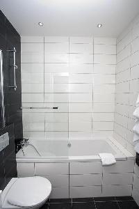 en-suite bathroom with a sink, a toilet, and a full bath with a detachable shower head in paris luxu