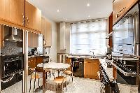 well-equipped kitchen with breakfast table in paris luxury apartment