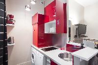 1-bedroom Paris luxury apartment with equipped kitchen in red hue