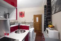 1-bedroom Paris luxury apartment with equipped kitchen in red and white hues