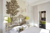 clean and crisp bedroom linens in Marais - Saint Claude luxury apartment