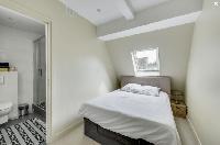 cozy double bedroom and sleek en suite bath in Paris luxury apartment