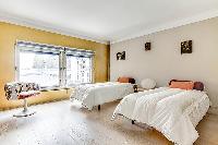 second bedroom with two single beds in a Paris luxury apartment