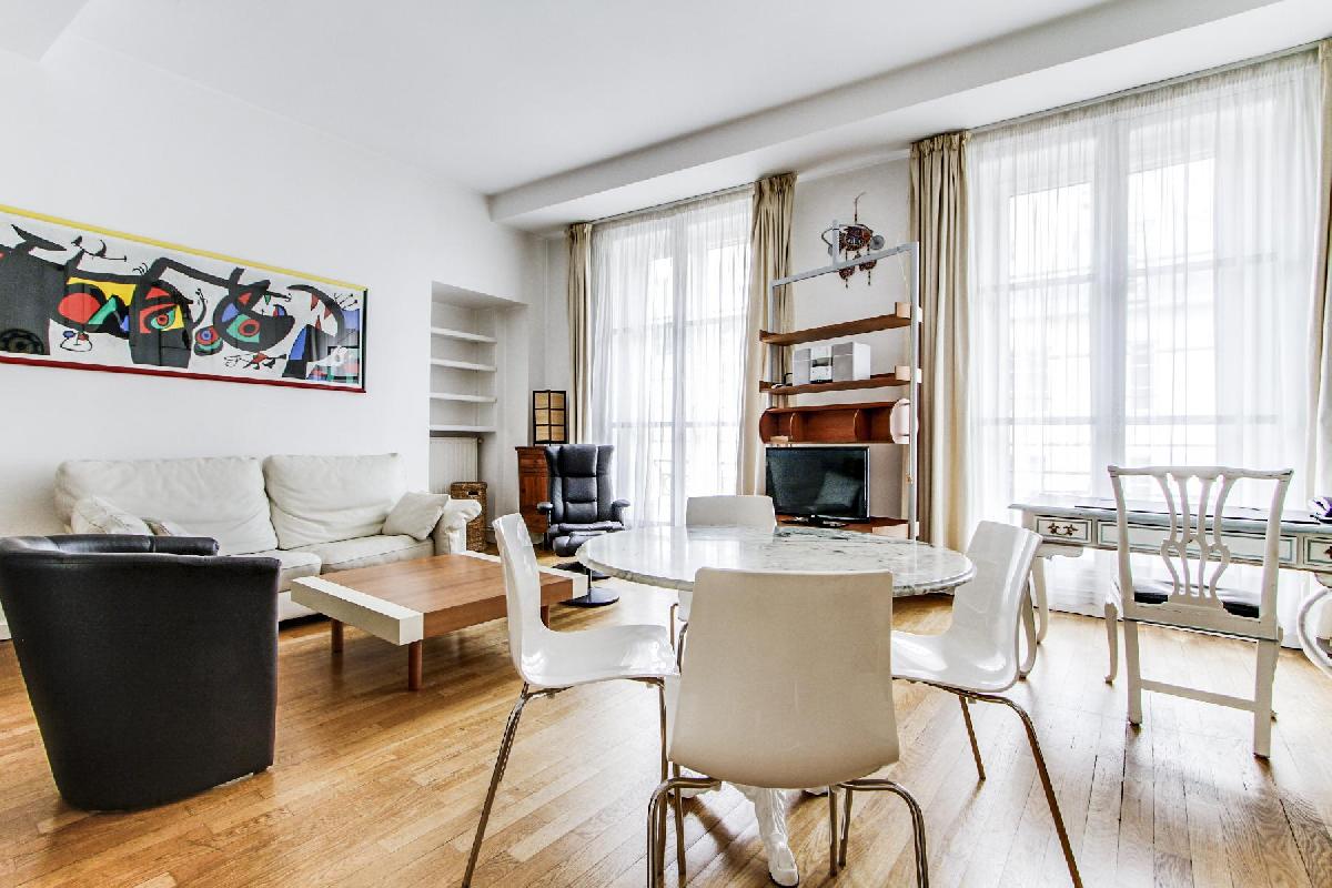 lovely dining area with white round table and 4 chairs in a 2-bedroom Paris luxury apartment