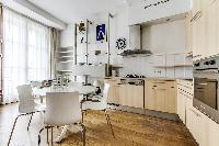 lovely kitchen and dining area with double-glazed windows in a 2-bedroom Paris luxury apartment