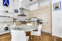 modern kitchen and dining area in a 2-bedroom Paris luxury apartment