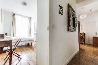 second bedroom and hallway in rustic design in a 2-bedroom Paris luxury apartment