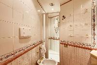 en-suite bathroom with a toilet, a bidet, a sink, and a shower area in a 3-bedroom Paris luxury apar