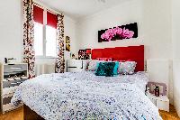 brand-new queen-size bed in the Master bedroom of a 2-bedroom Paris apartment