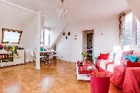 cozy living and dining area with wooden floors in a 2-bederoom Paris apartment