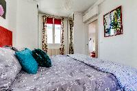 brand-new queen-size bed in the Master bedroom of a 2-bedroom Paris apartment
