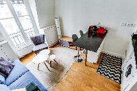 living area and dining area with comfortable blue sofa and breakfast bar