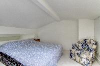 brand-new queen-size bed in the bedroom with sofa