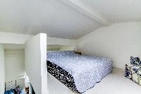 brand-new queen-size bed in the bedroom with sofa
