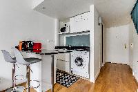 modern studio loft with well-equipped kitchen and breakfast bar in Paris