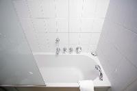 white bathroom with a bathtub in a 1-bedroom Paris luxury apartment