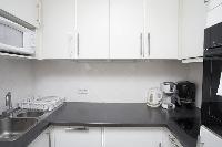 well-equipped kitchen in a 1-bedroom Paris luxury apartment