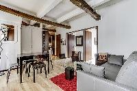 dining area with dining table and four Roche et Bobois chairs in a 2-bedroom Paris luxury apartment